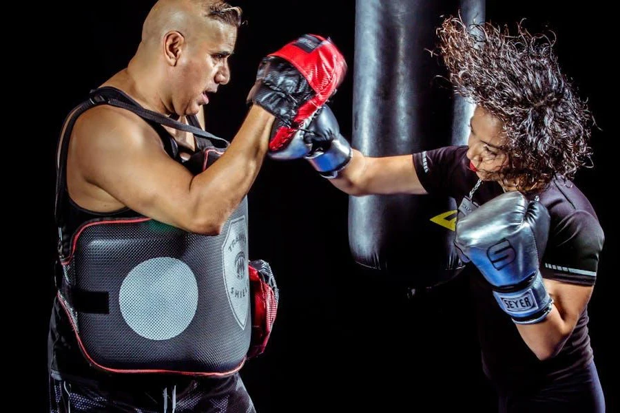 Two people sparring with boxing gloves