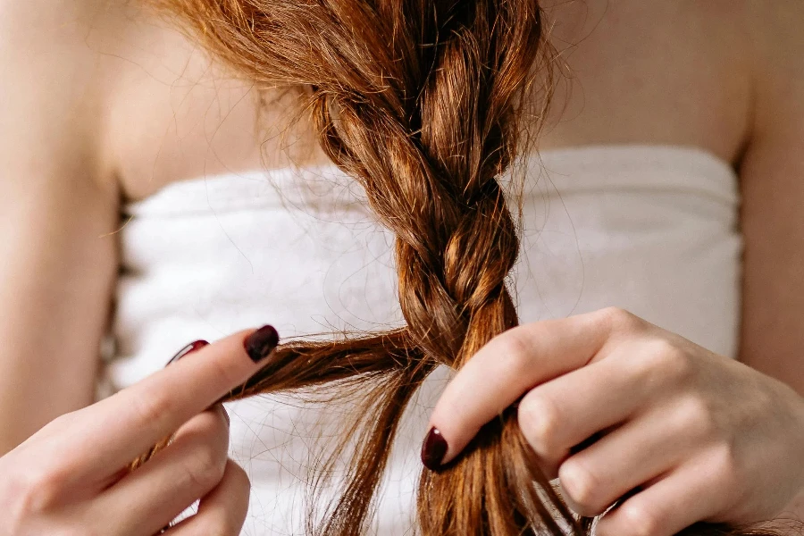 Woman braiding her Hair