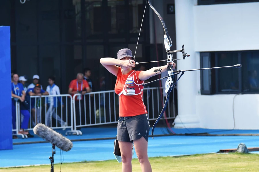 Woman competing at a professional archery match
