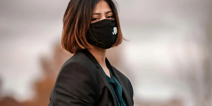 Woman in Black Blazer Wearing a Black Face Mask