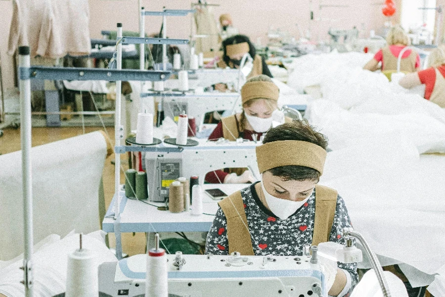 Women Wearing Face Masks Working in a Sewing Factory by Ivan Samkov