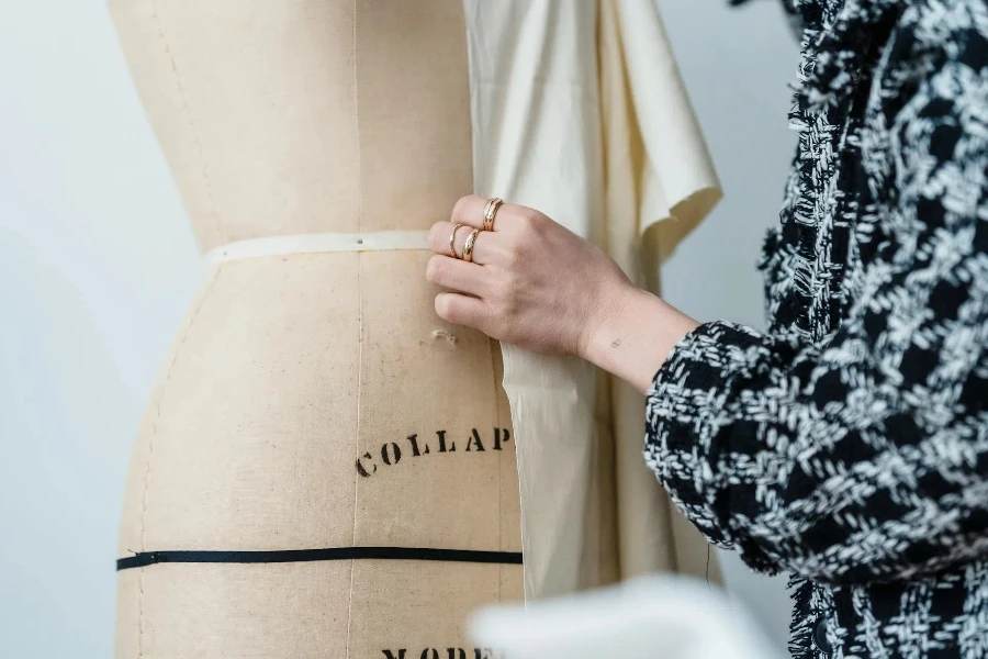 A designer working with fabric and mannequin