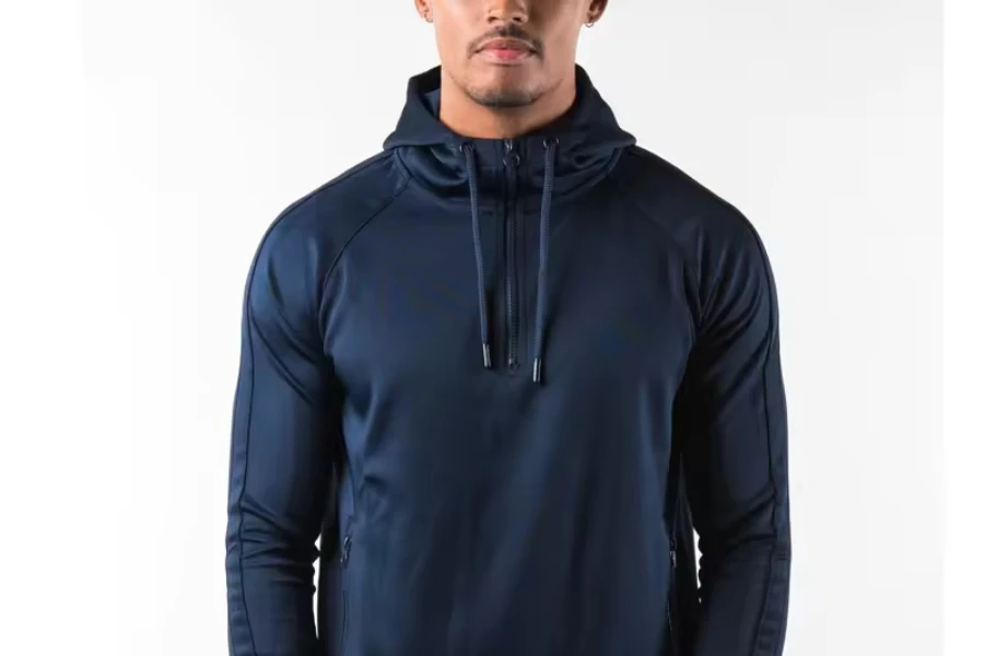 A man wearing a half-zip hoodie