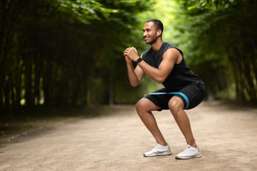 Motivated handsome muscular millennial black man exercising