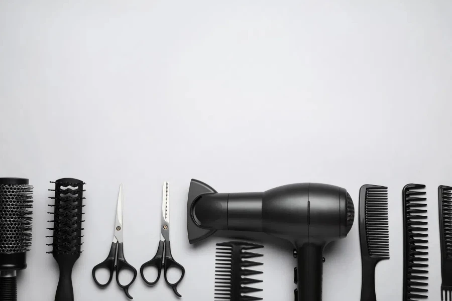 Flat lay composition of professional hairdresser tools