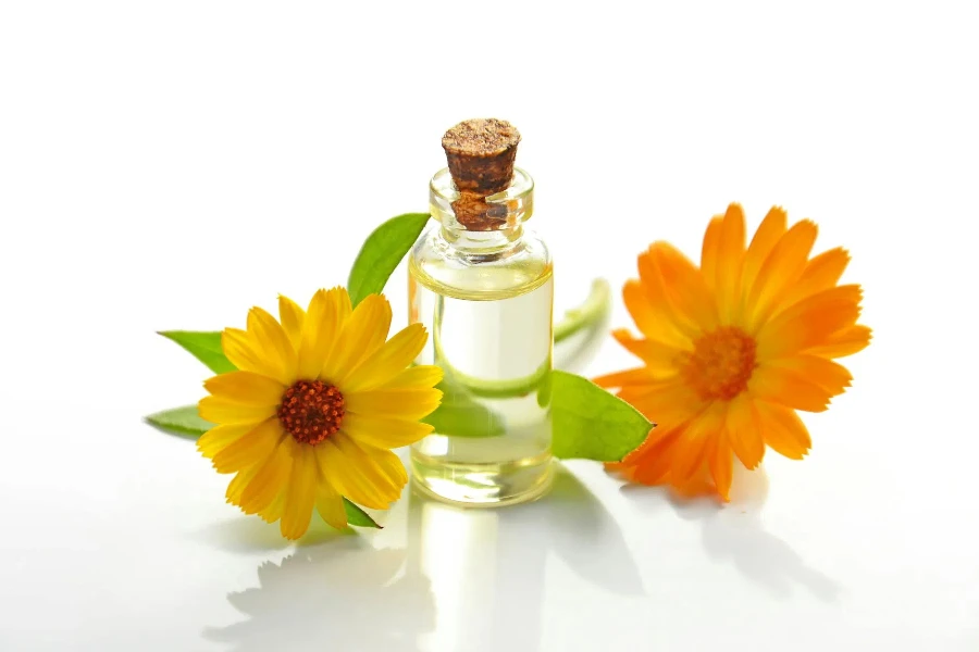 Two Yellow Sunflowers With Clear Glass Bottle With Cork Lid