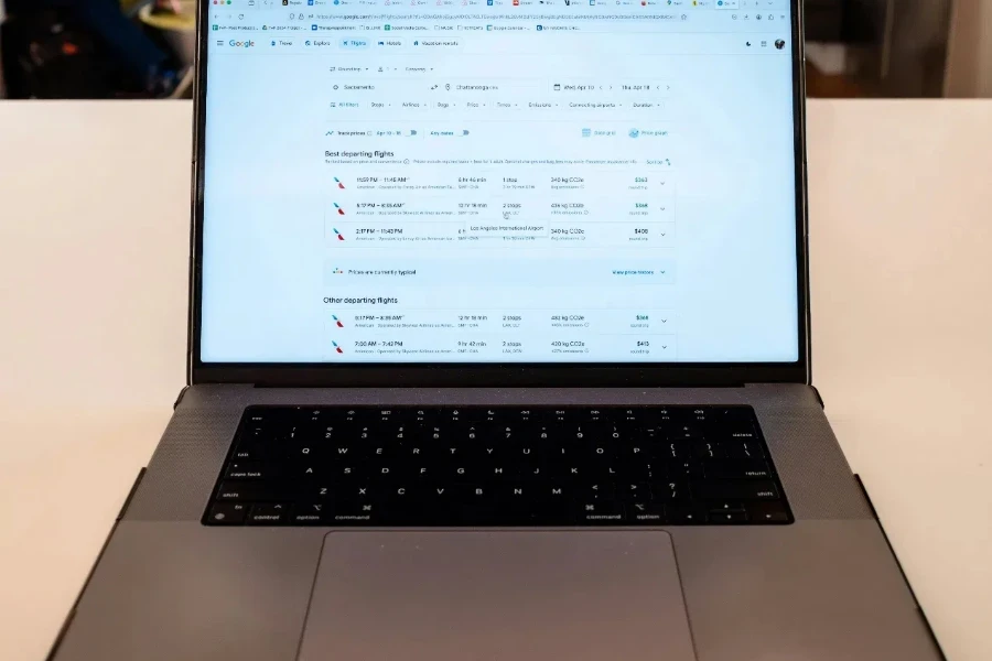 A laptop computer sitting on a table in a cafe