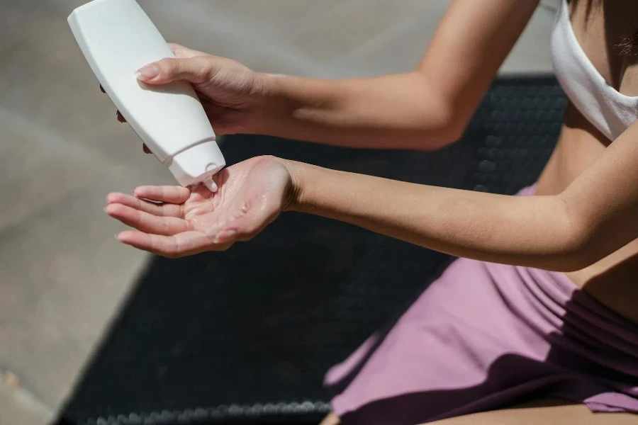 woman applying lotion on hand