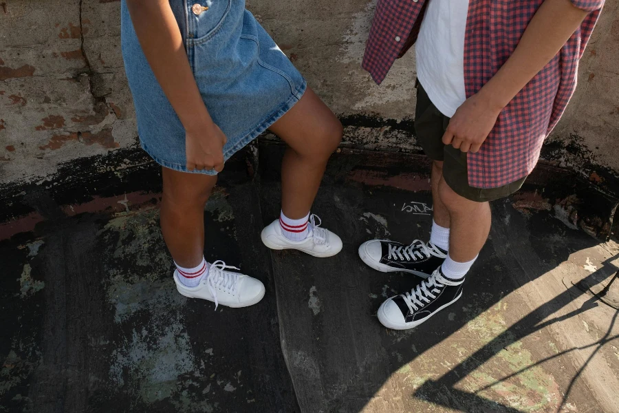 Sneakers on legs of teenagers facing each other