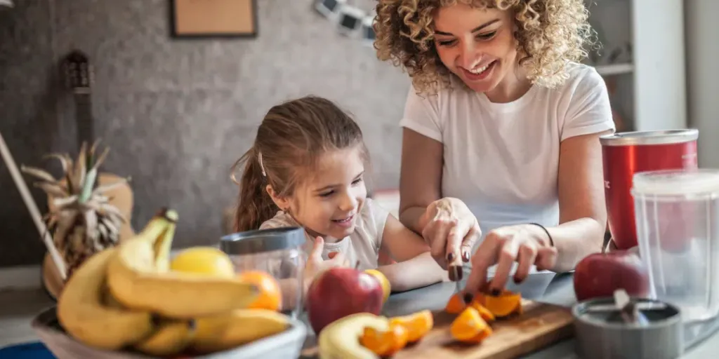 mother and daughter making smoothie