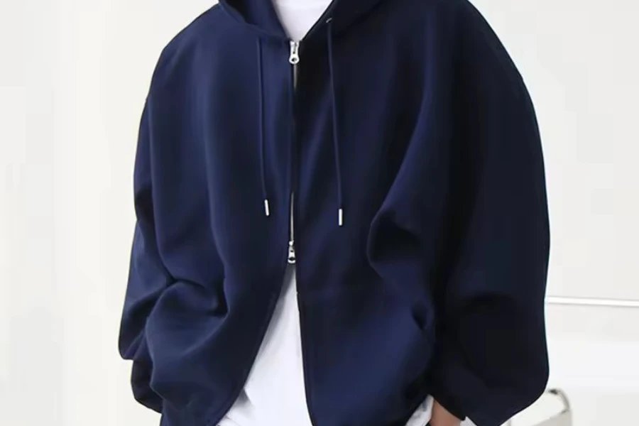 Person wearing a unisex double zipper hoodie