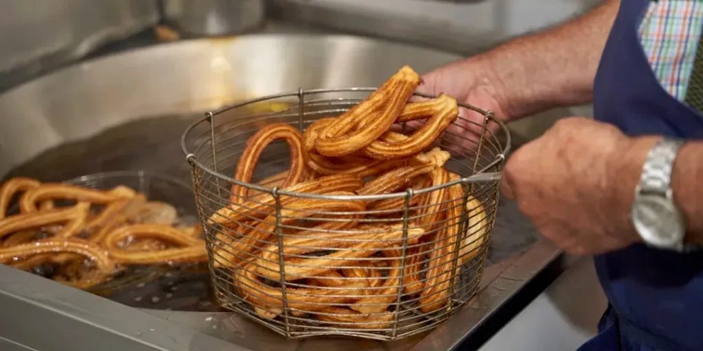 senior cook removing churros