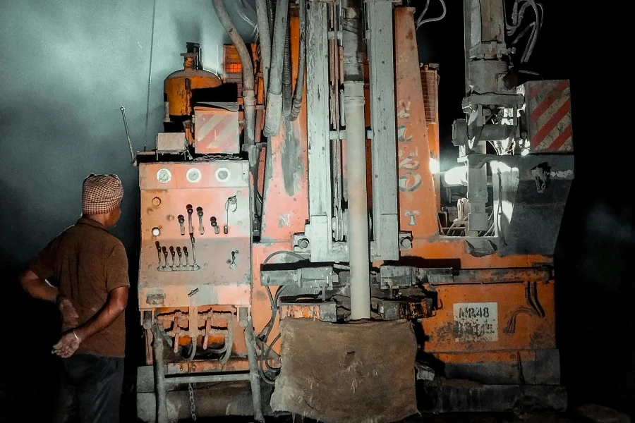 a man is looking at a boring machine