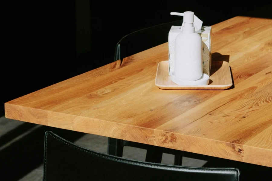 A Pump Bottle and Box of Tissue on a Wooden Table