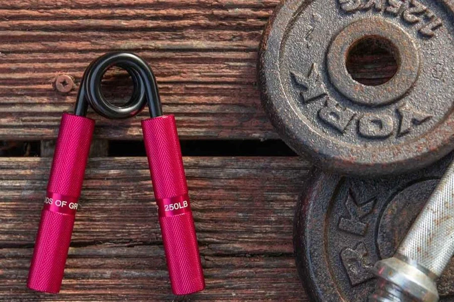 A coil grip trainer next to some free weights