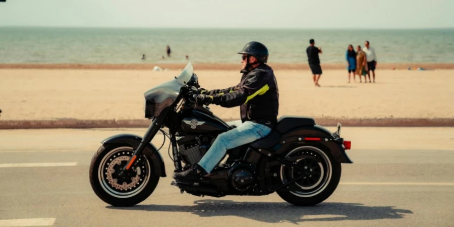 A man riding a motorcycle on the beach