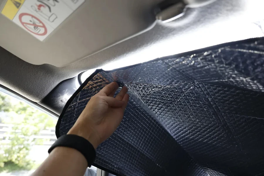 A sunshade attached to the windshield of an automobile