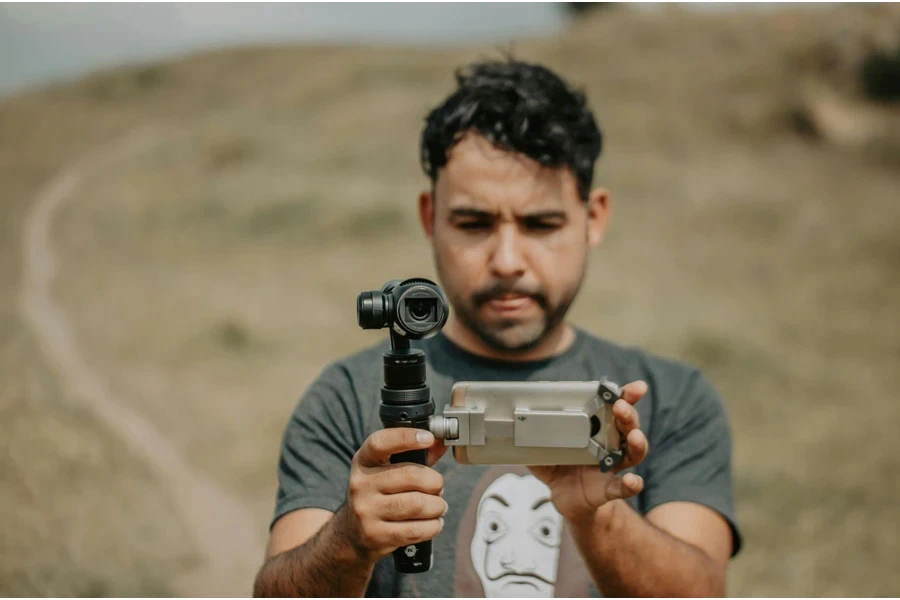 Man holding a Mini Camcorders