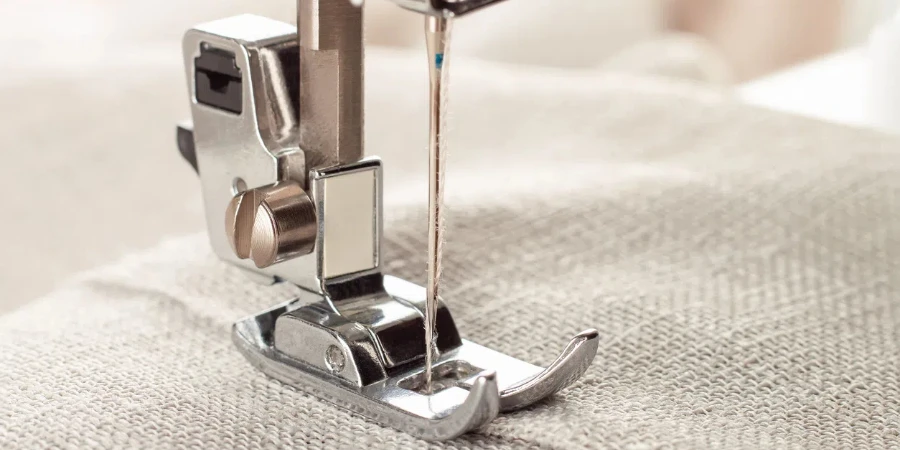 Modern sewing machine presser foot with linen fabric and thread,