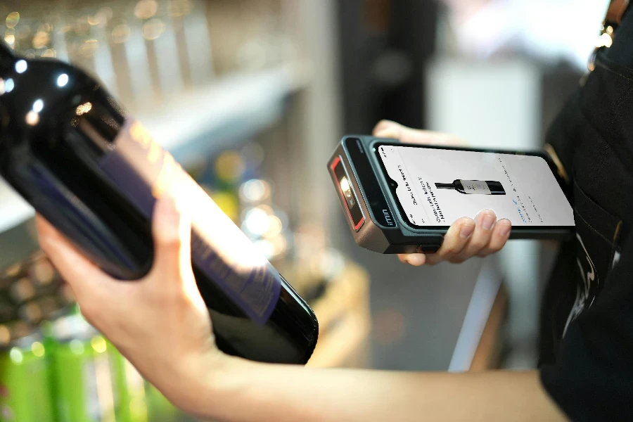 Person Using Scanner on Bottle of Wine