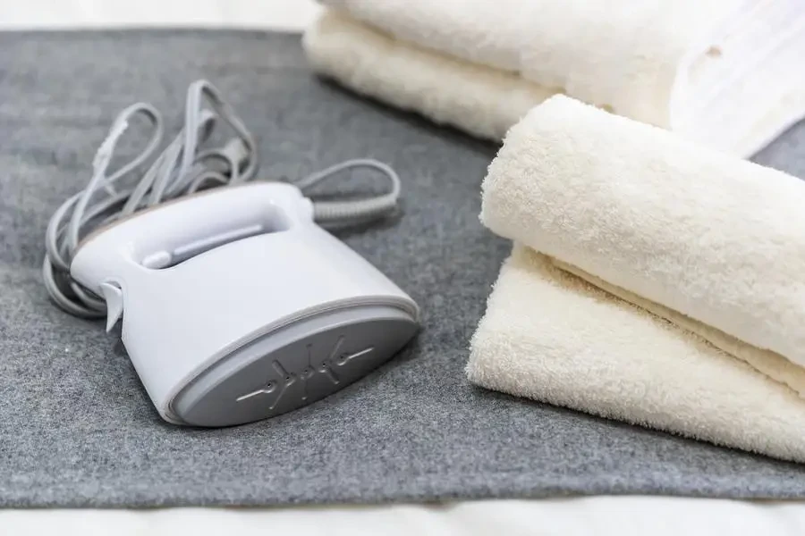 Portable iron and towels placed on the bed