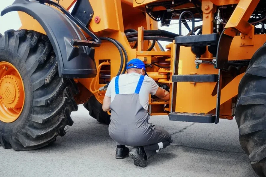 Profesyonel tamirci tekerlekli traktör veya buldozer tamir eder