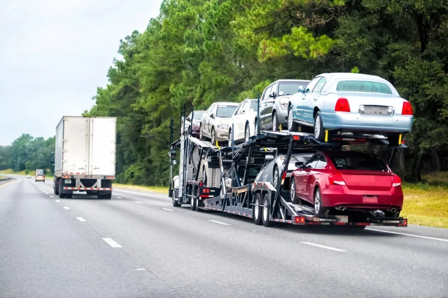 Truck trailer hauler transportation, commercial transport hauling brand new cars for auto dealership on Florida highway road