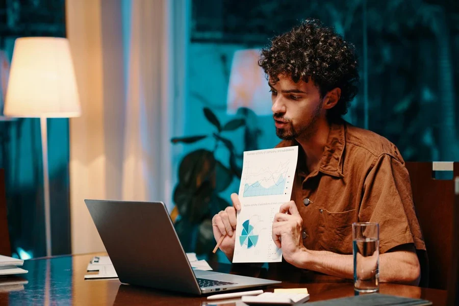 Young businessman showing report to his client at online meeting