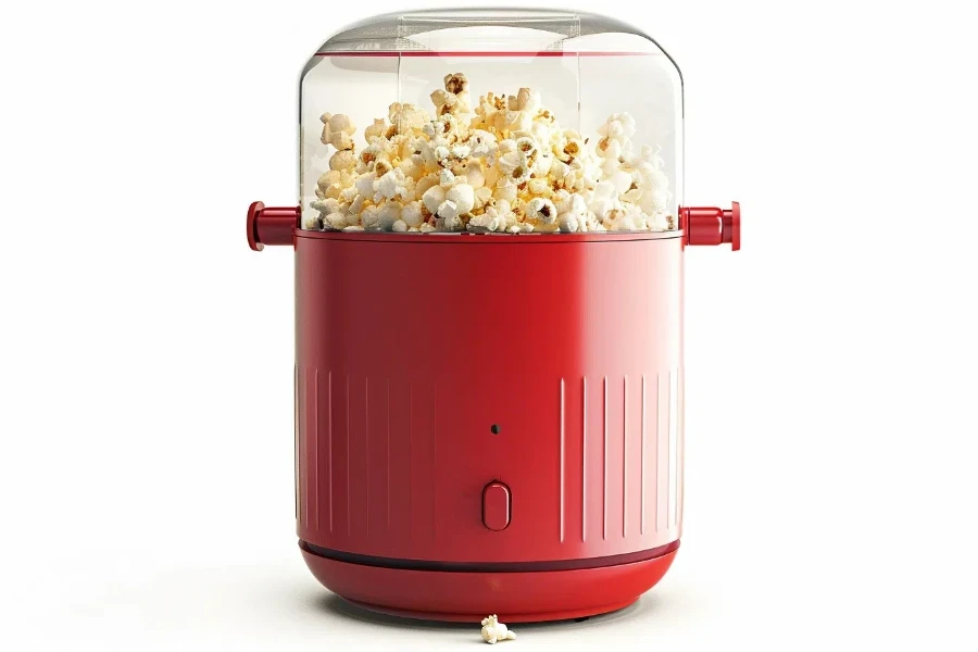 a red popcorn maker with a clear lid