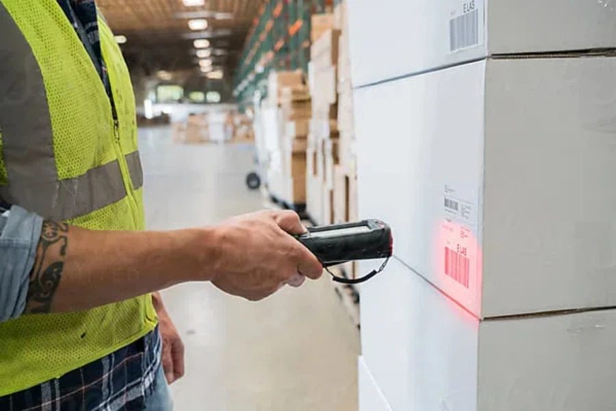 Warehouse worker using hand held scanner