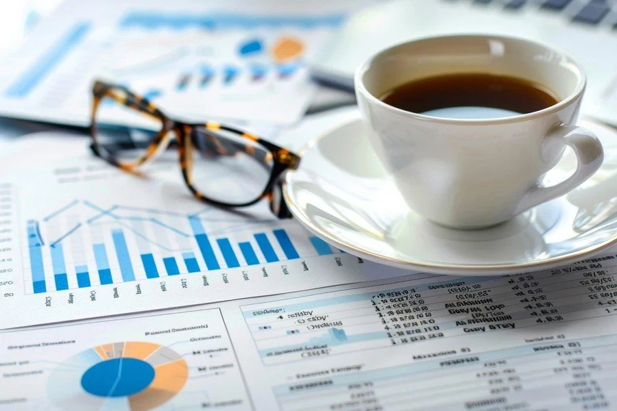 A cup of coffee and glasses on a table