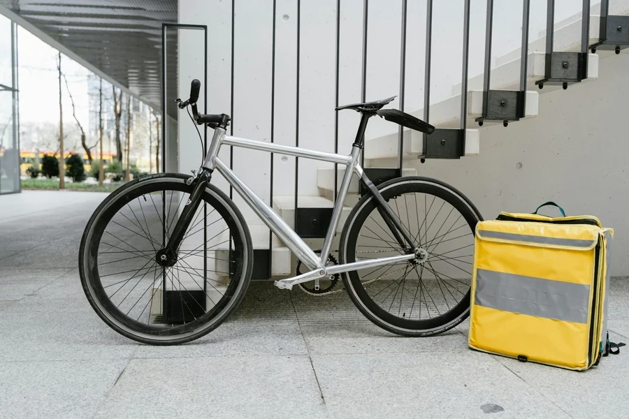 Black and Gray Bicycle Beside a Yellow Bag