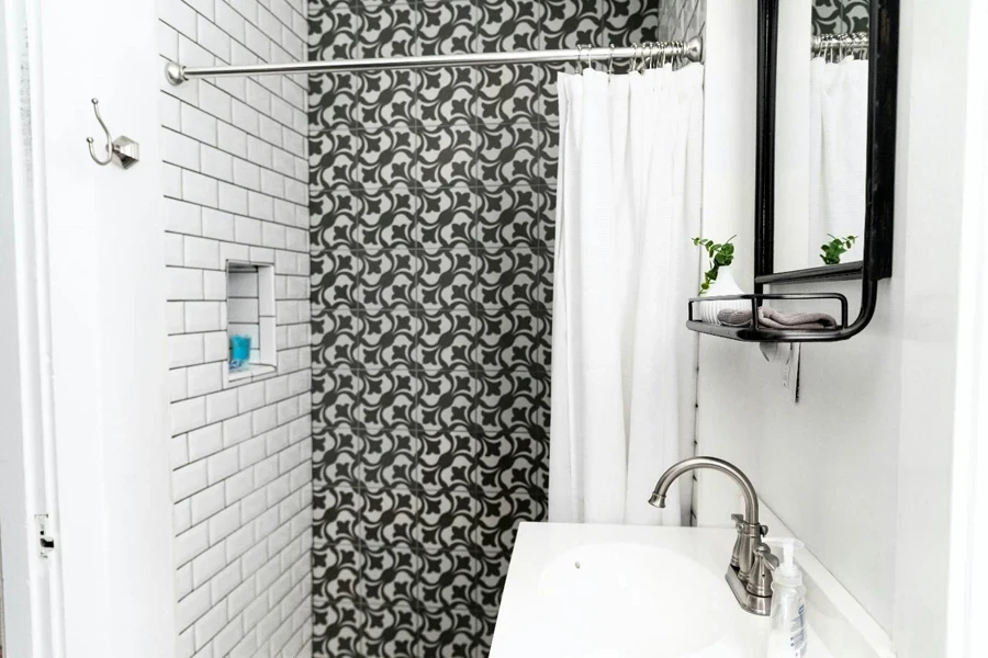 Contemporary bathroom interior with brick wall in shower room near washbasin and mirror in house