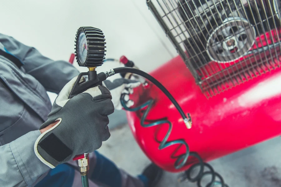 Garage Air Compressor. Adjusting Pressure in a Car Tires.