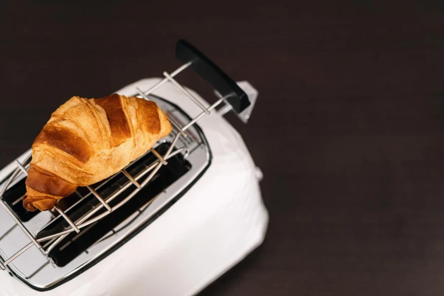 Croissant francés dorado con corteza crujiente calentado en una tostadora