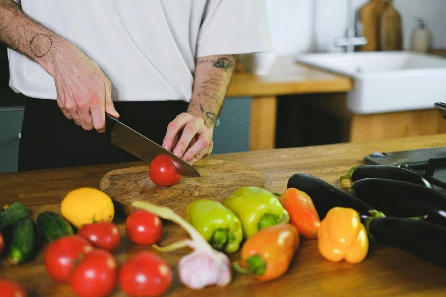 Man Cutting a Tomato