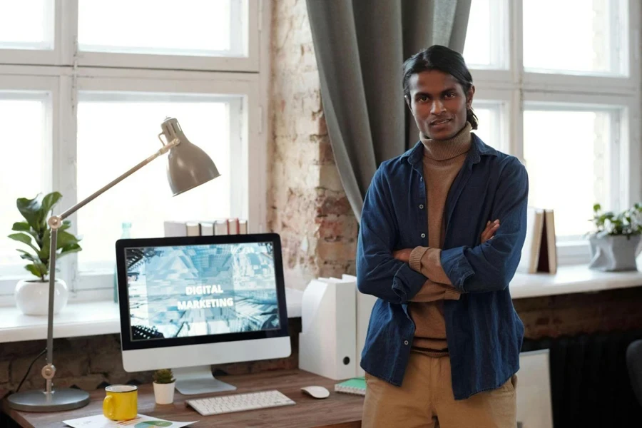 Man in Roll-neck Sweater Standing Beside the Table