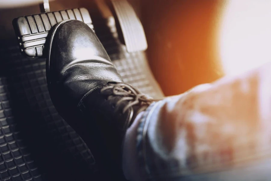 Man stepping on car brake To slow down