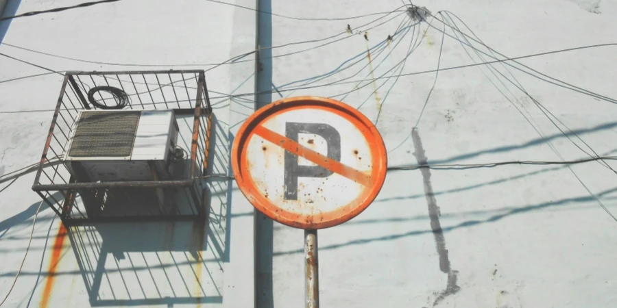 Rusty Caged Air Conditioner Behind No Parking Sign