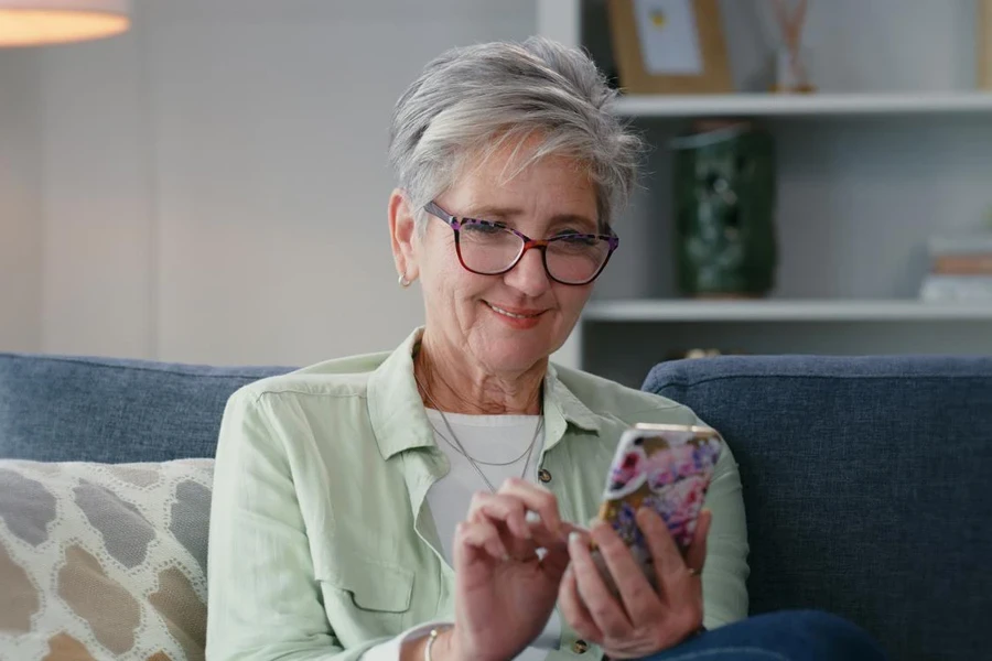 Senior Woman with Trendy Mushroom Haircut Using Phone