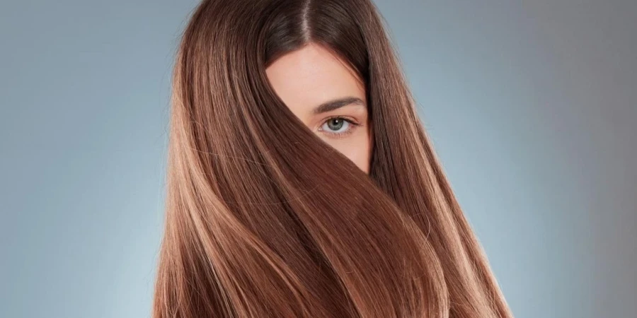 Studio shot of a beautiful young woman showing off her long brown hair