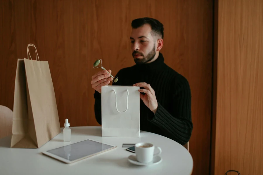 Stylish Man Unpacking Shopping Bag