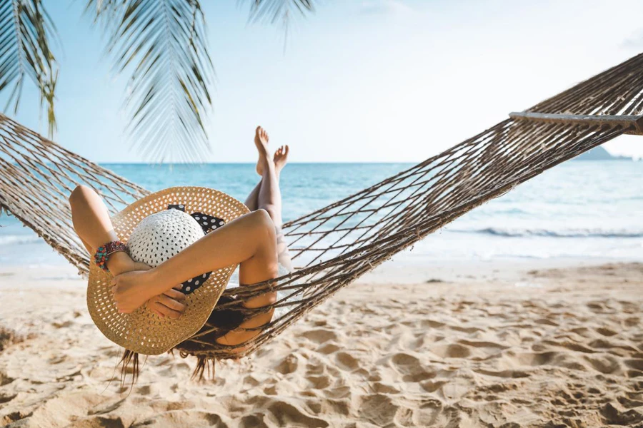 Traveler asian woman relax in hammock on summer beach Thailand