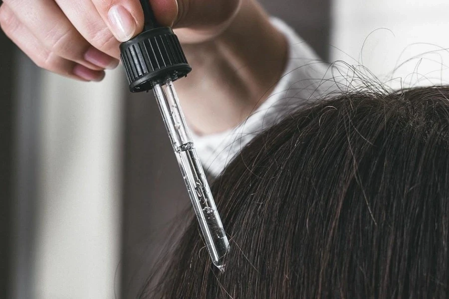 Woman applying hair loss concealer