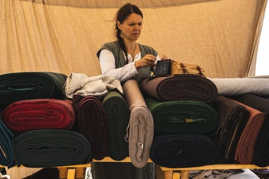 Woman putting bag above fabric