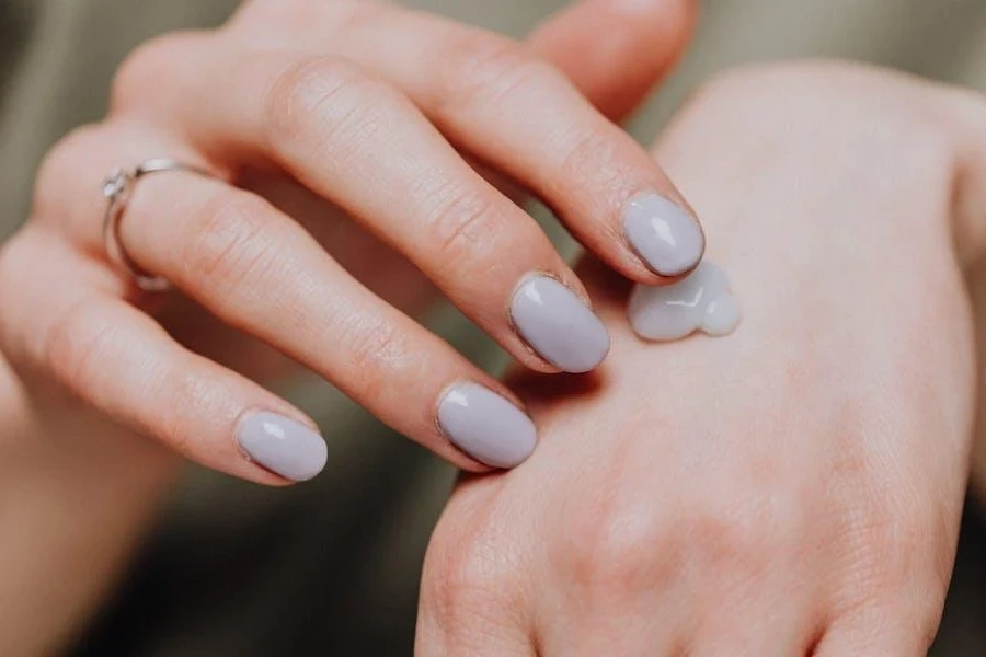 Woman with ring applying hand cream