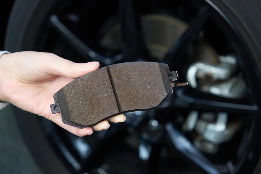 Woman's hand holding brake pad