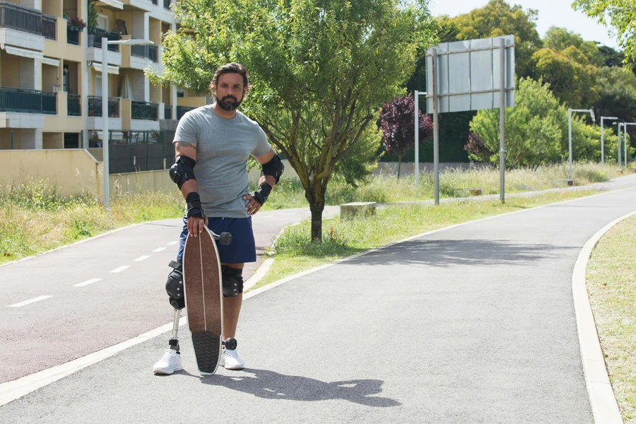 A Man Standing on the Street while Holding a Skateboard