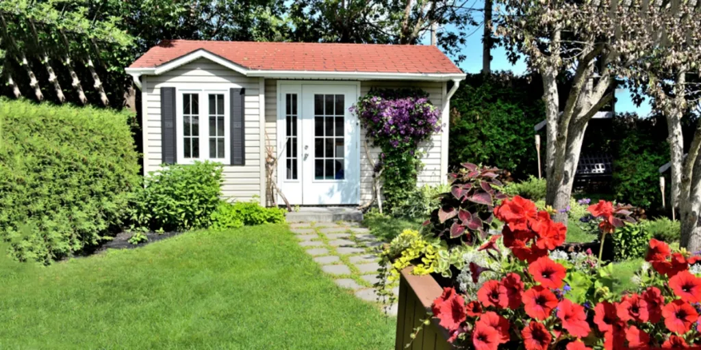 Un studio à l'arrière entouré d'un beau jardin