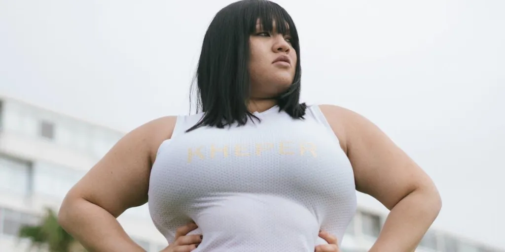 A plus-sized woman in a white tank top